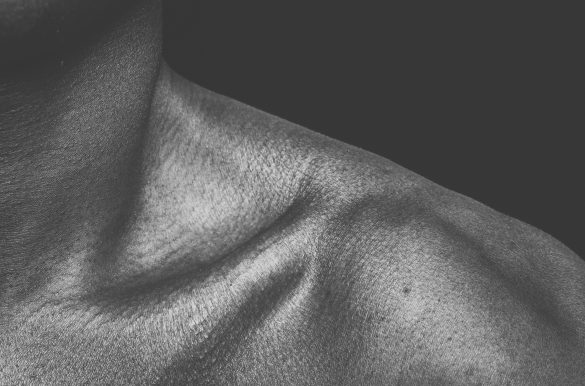 Close up human shoulder in black and white.